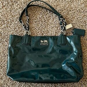 Coach Tote 15 inches across and 9.5 inches deep. 3 inside pockets. Teal patent